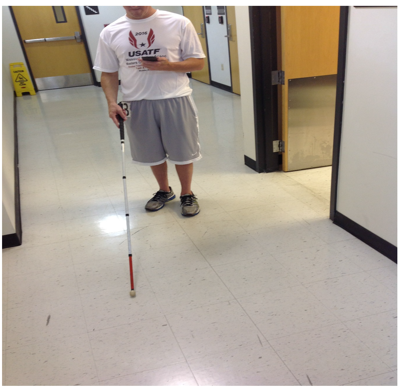 Visually impaired user with cane using the CityGuide application