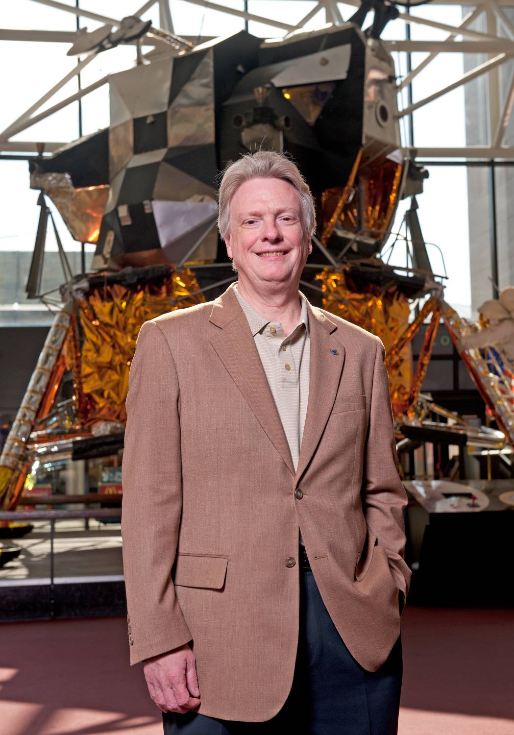 Dr Roger Launius in front of a moon lander
