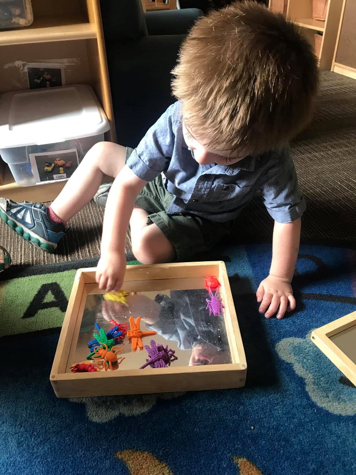 Child interacts with activity box