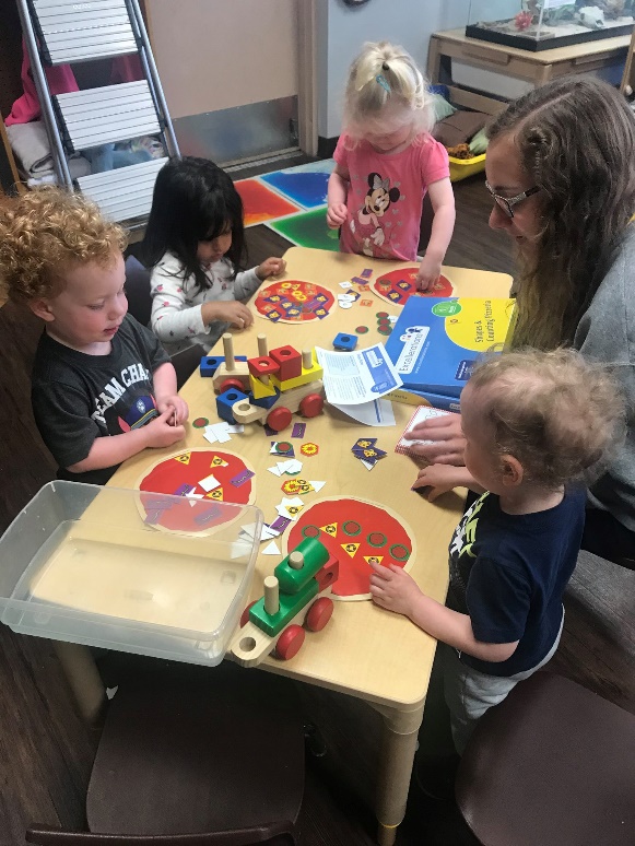 Children interact with shape counters and blocks