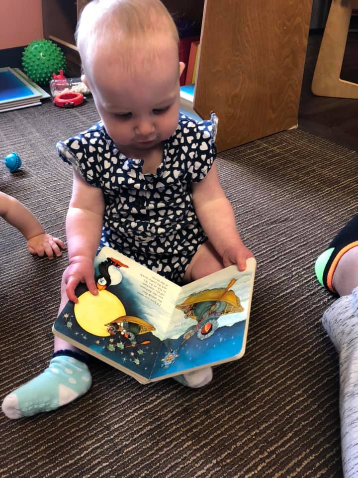 Baby reading in the book center