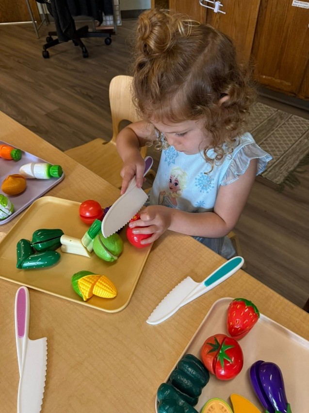 Child playing with play food