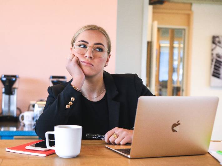 Dejected woman sitting with a computer