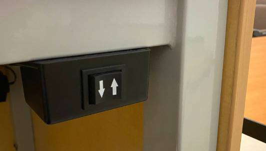 The up and down arrows on the lectern will adjust the height of the lectern to suit the user. The up and down arrows on the lectern will adjust the height of the lectern to suit the user.