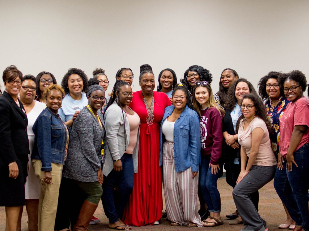 Members of Phenomenal Women taking a picture together with Tarana Burke.