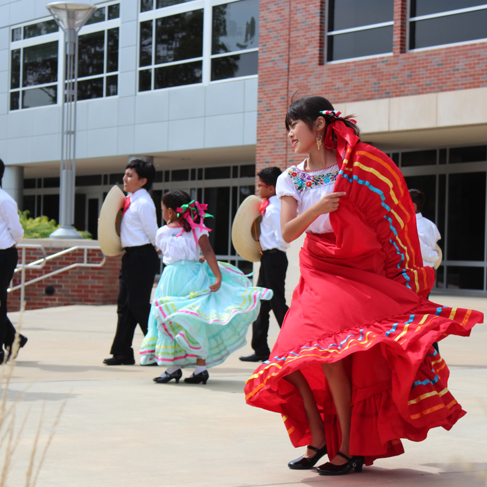 Young children dancing to a traditional song at Latinx Heritage Month Celebration.