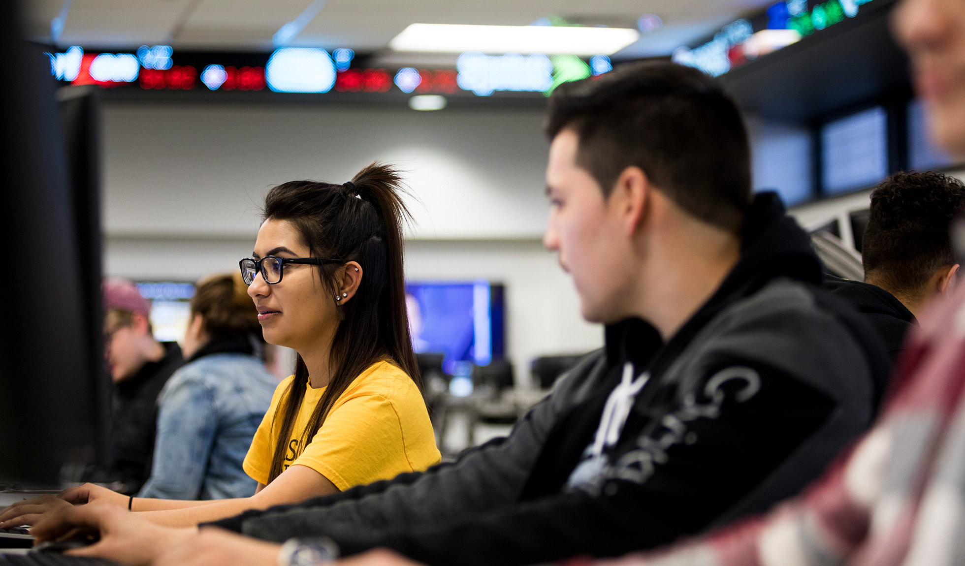 Two students working together in the Koch Trading Center.