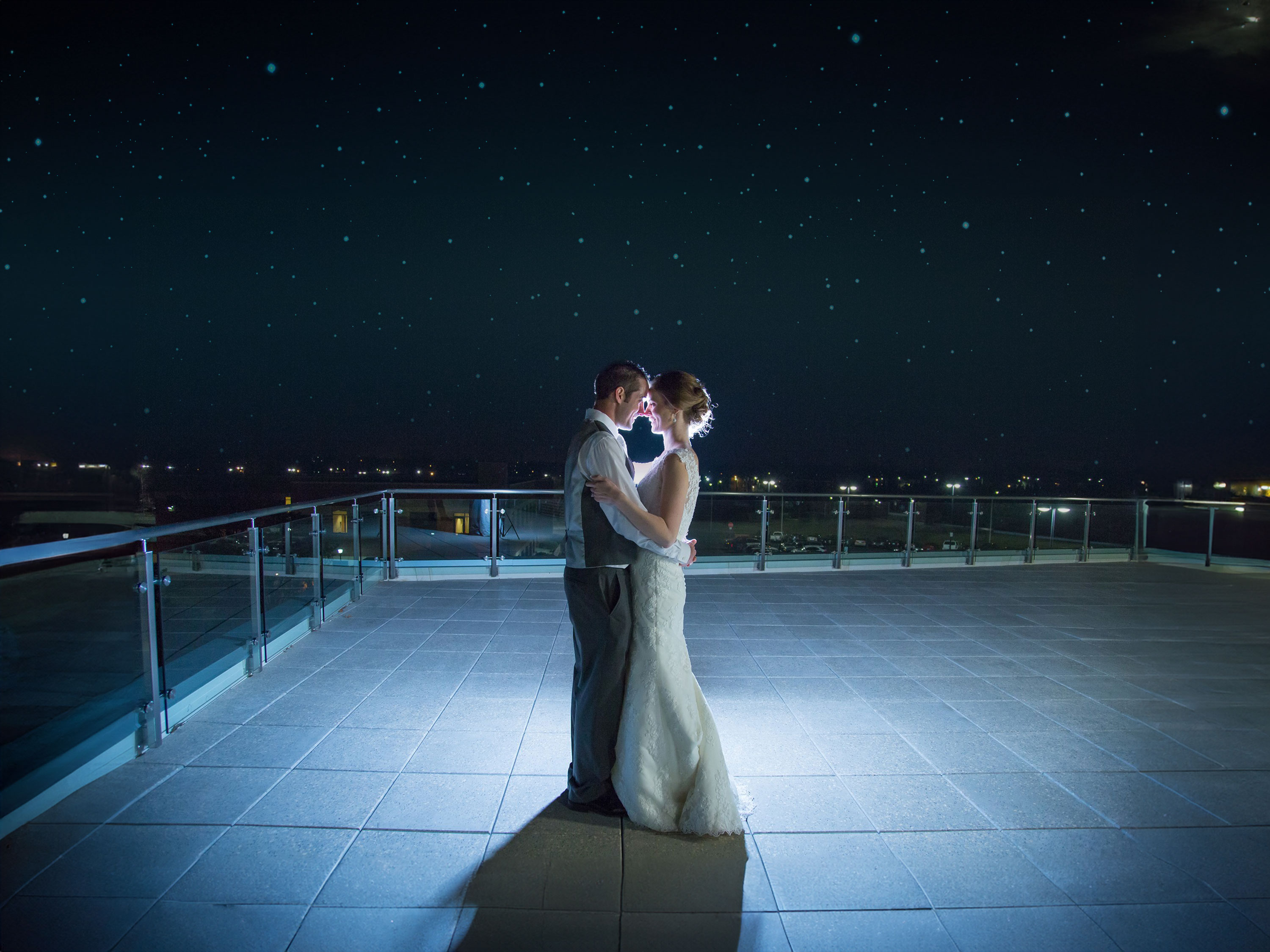 Newlywed couple dancing under the stars.