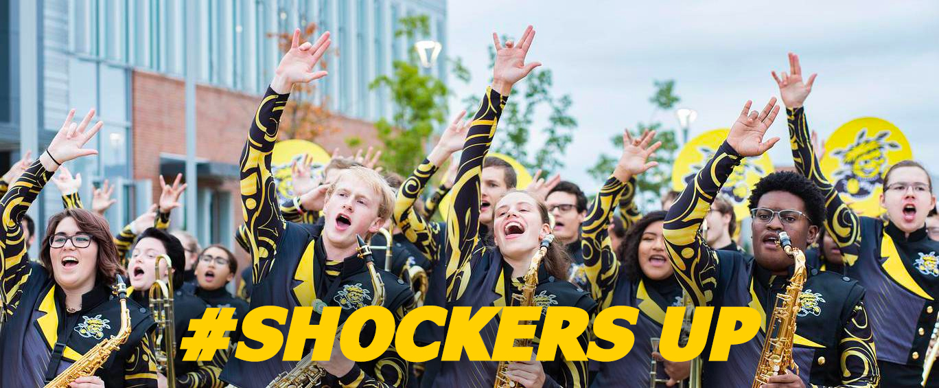 Shocker Sound band members showing the Shockers Up handsign