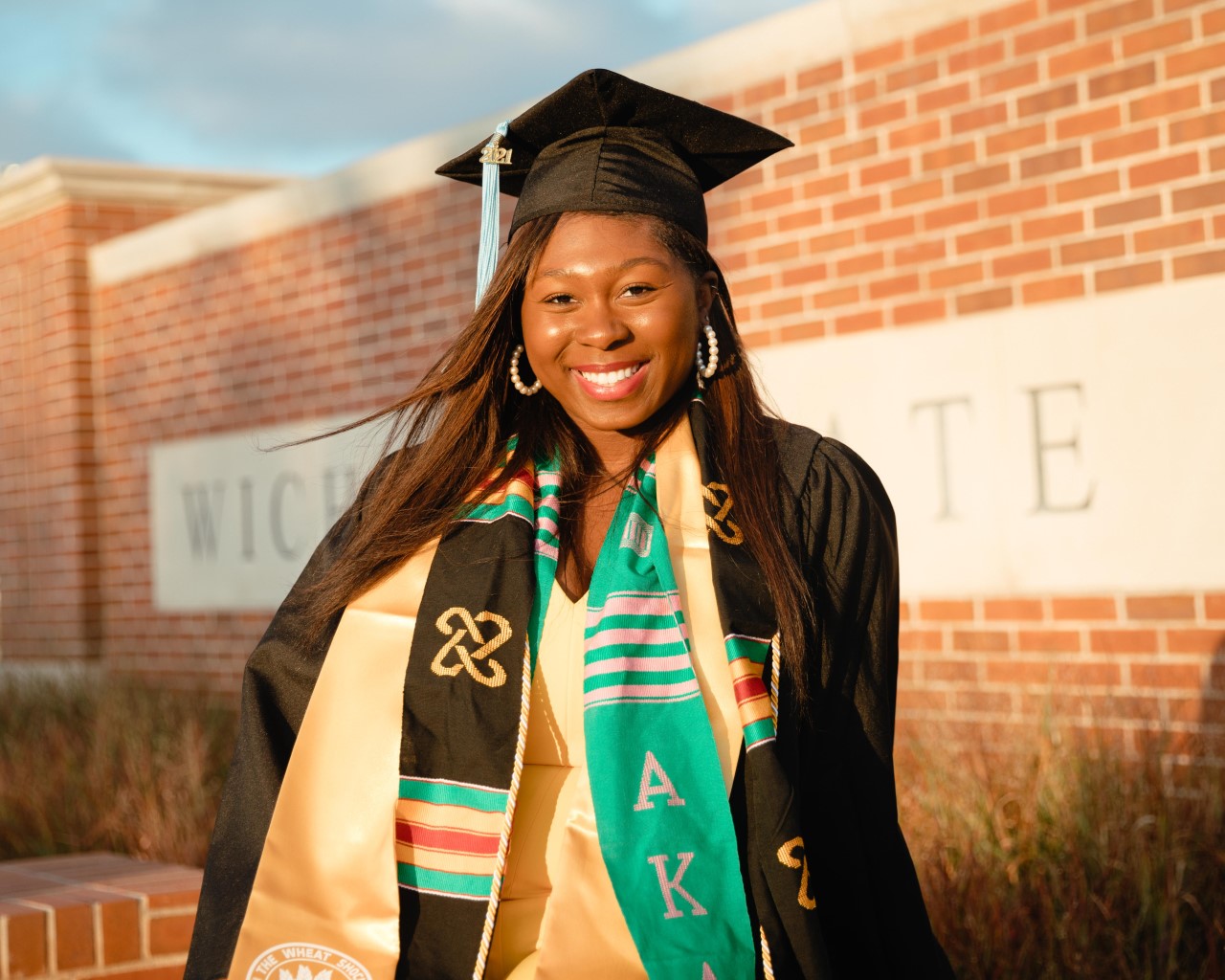 Black woman in graduation cap and gown with honors