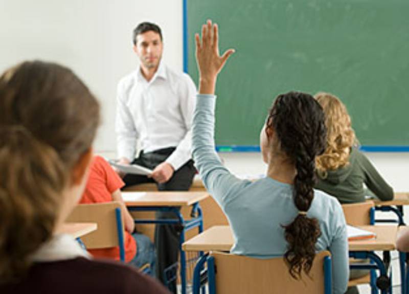 Student with hand up for a question