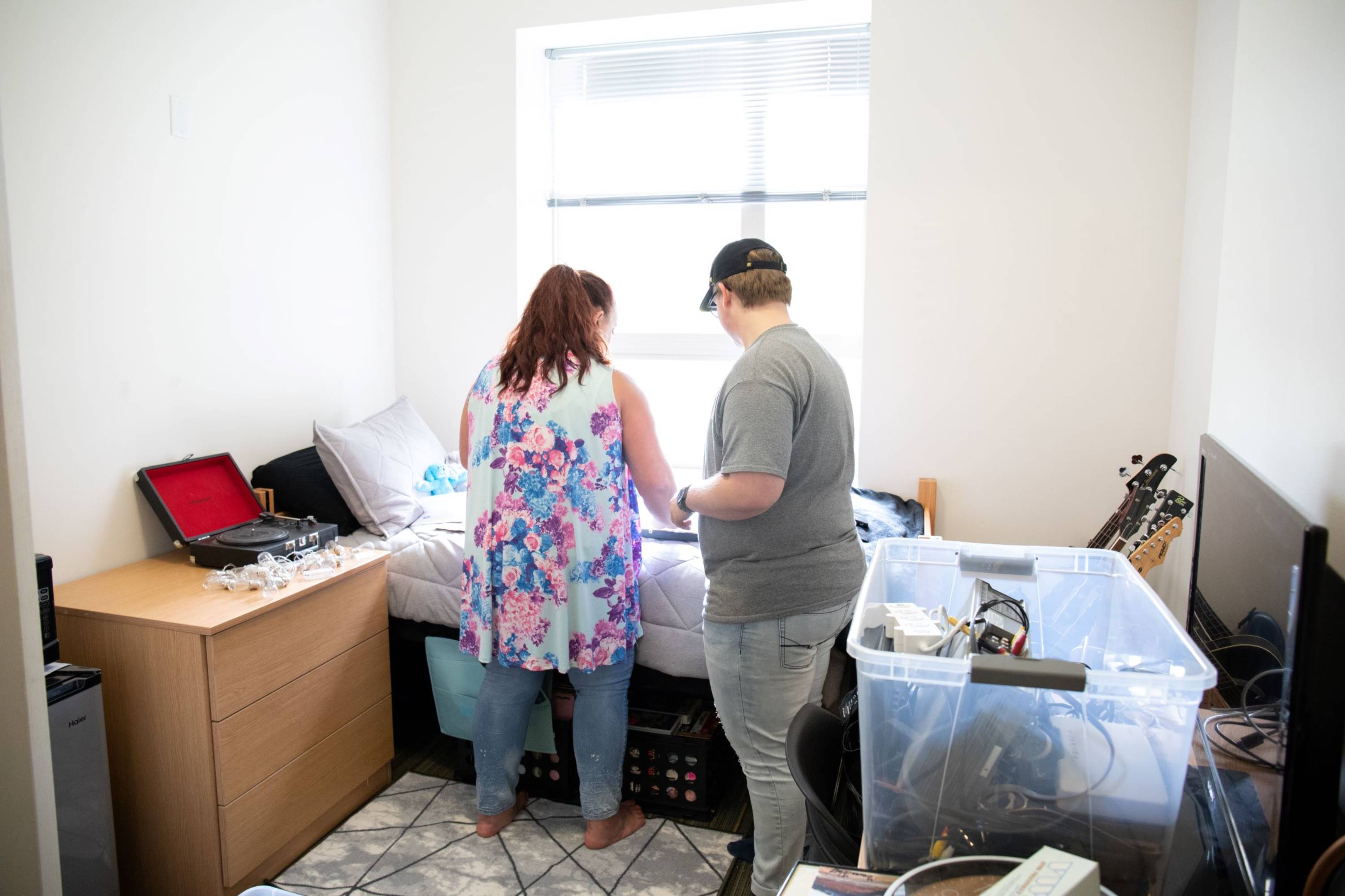 Mom helping their student move into a dorm room