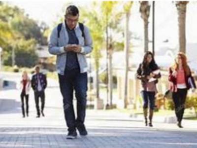 Man walking while looking at his phone Man walking while looking at his phone