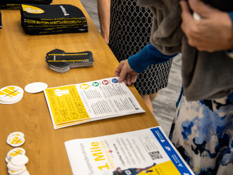 Table with HOPE flyers and buttons with hands grabbing