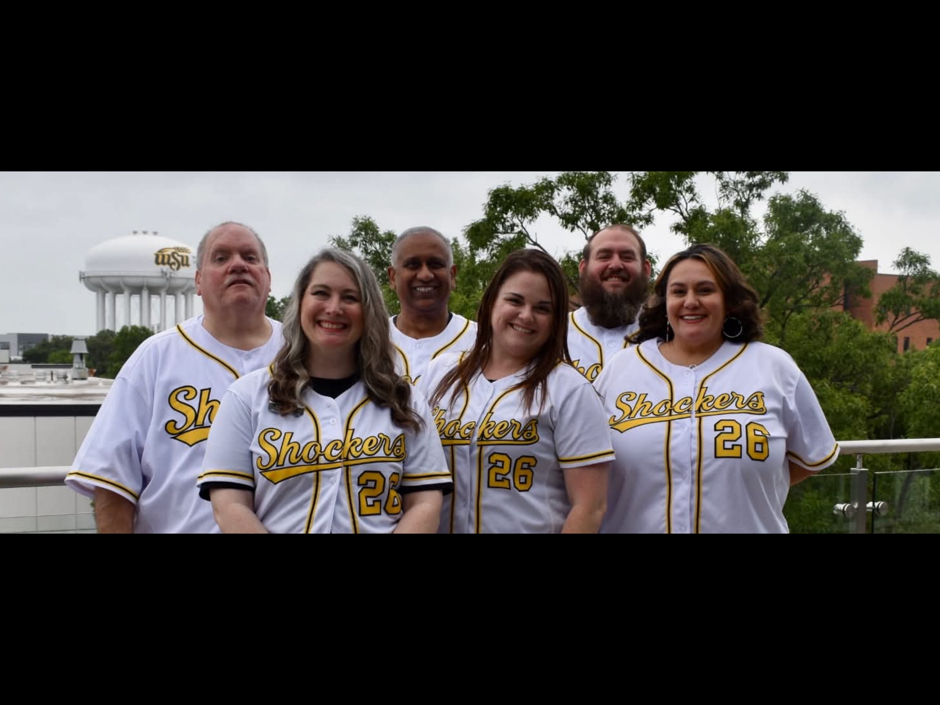 coaches standing together outside of RSC 3rd floor balcony.