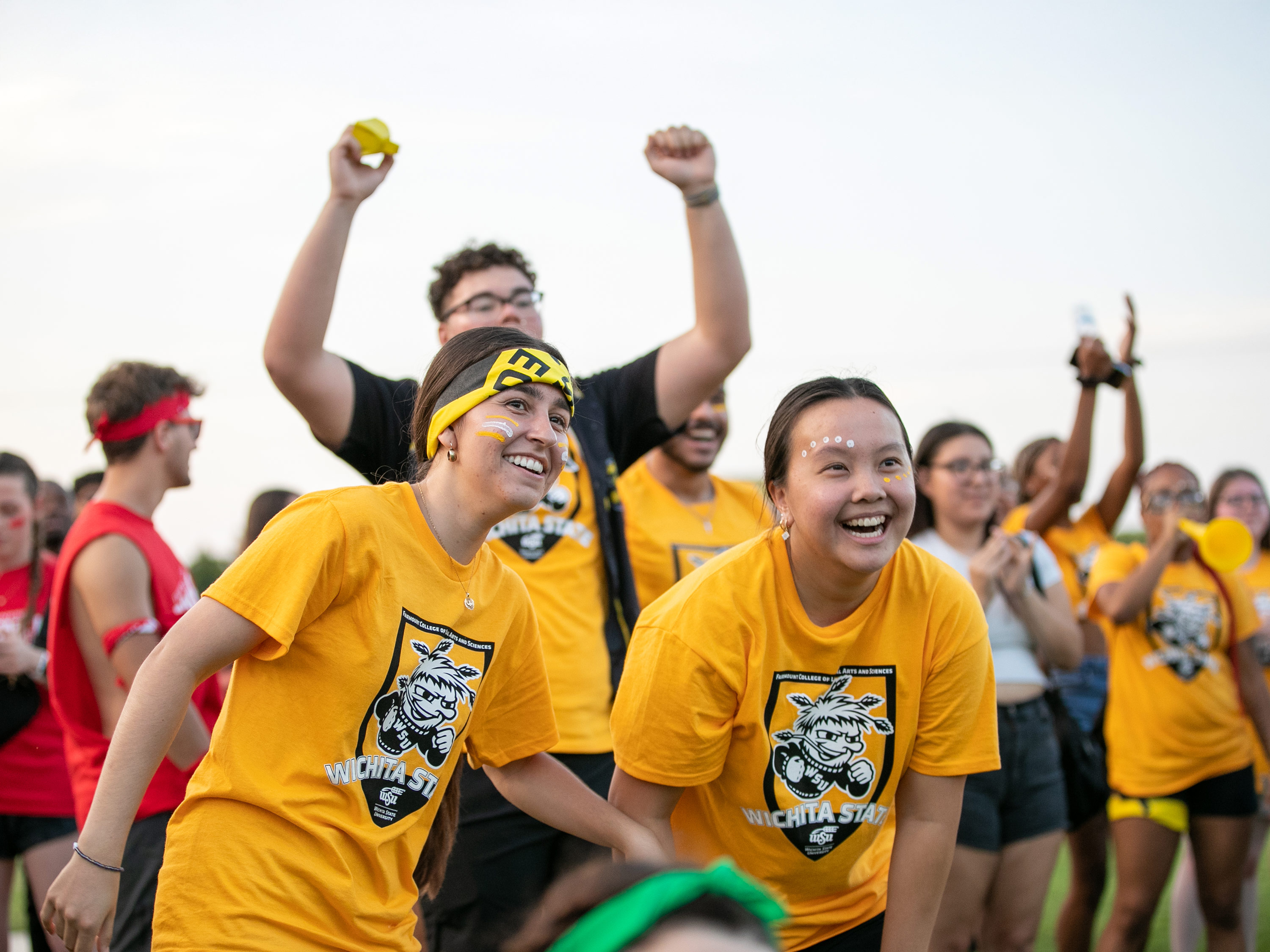 Students in yellow shirts celebrate at Clash of the Colleges.