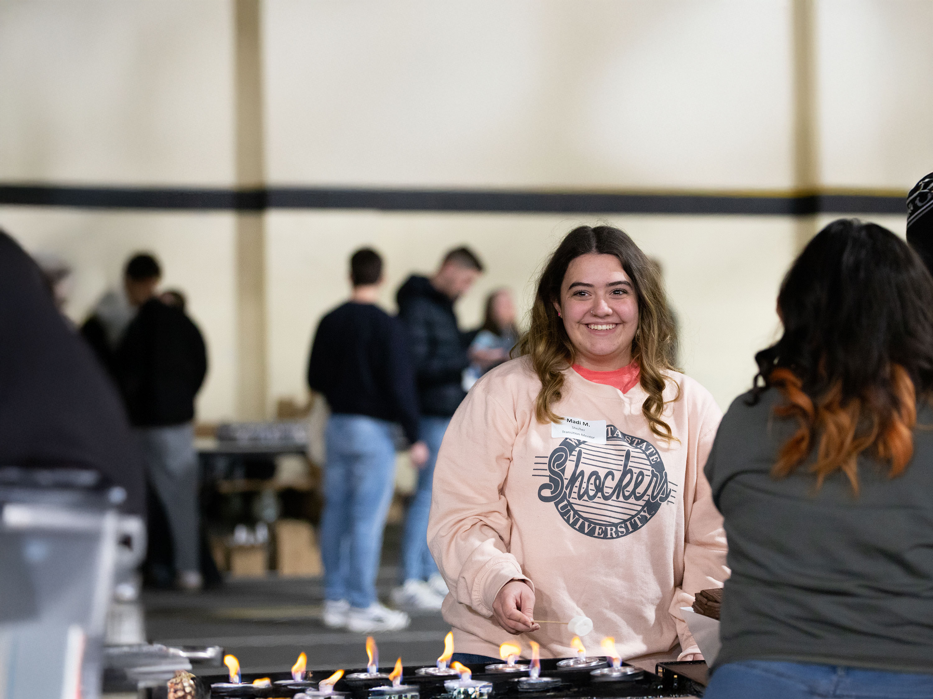 Students making treats at a s'mores station.