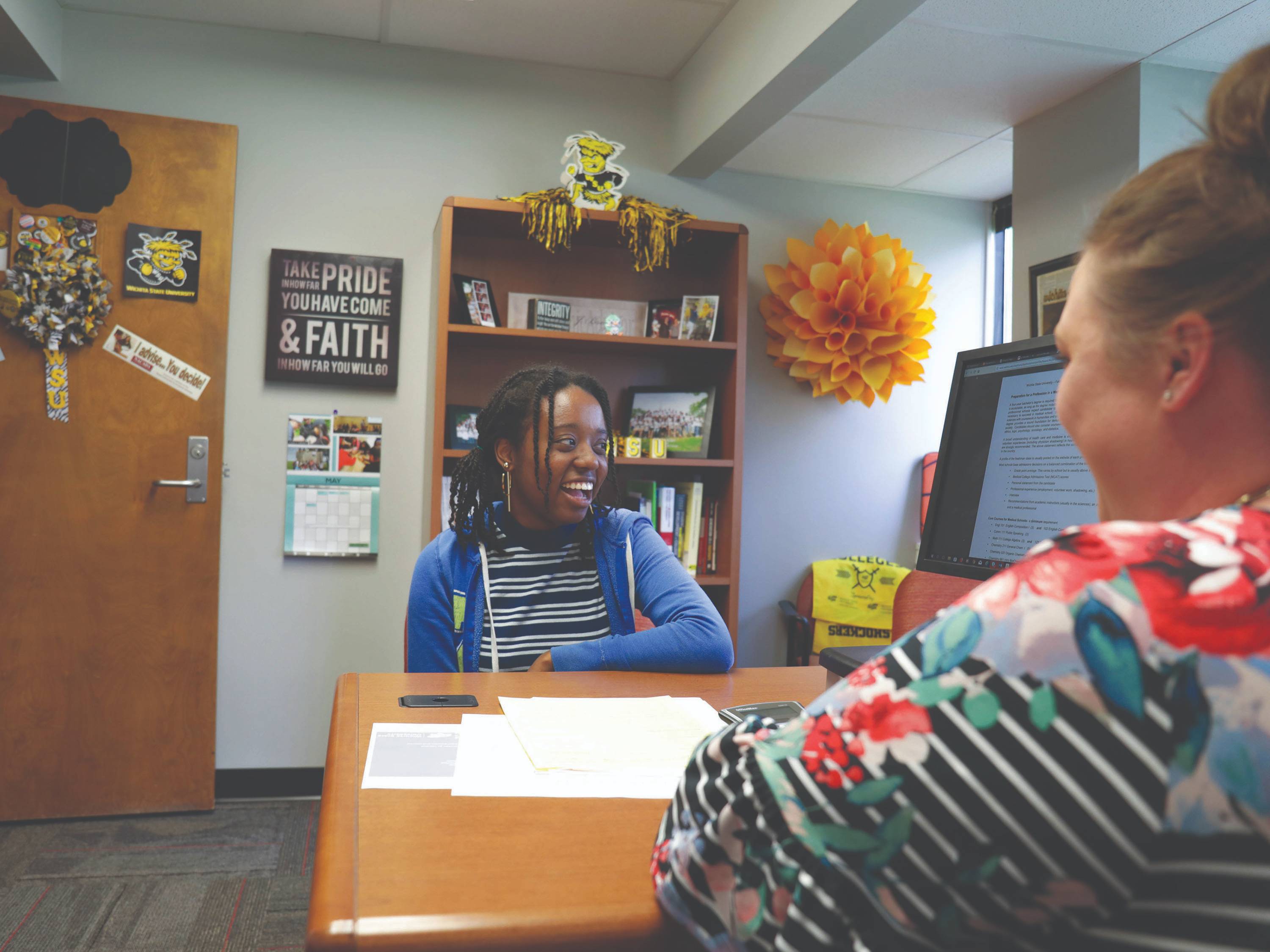 A student talks with her academic advisor
