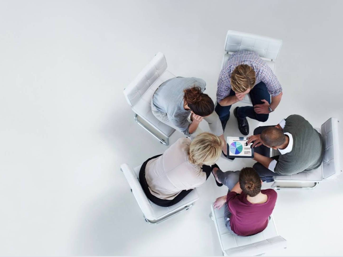 A group of people conferencing around a table.
