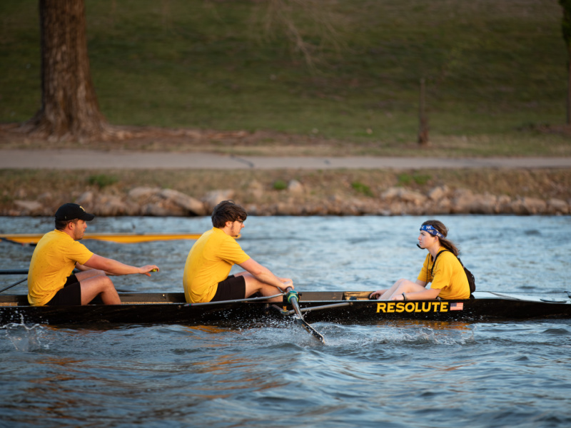 Men rowing in a shell with a coxswain