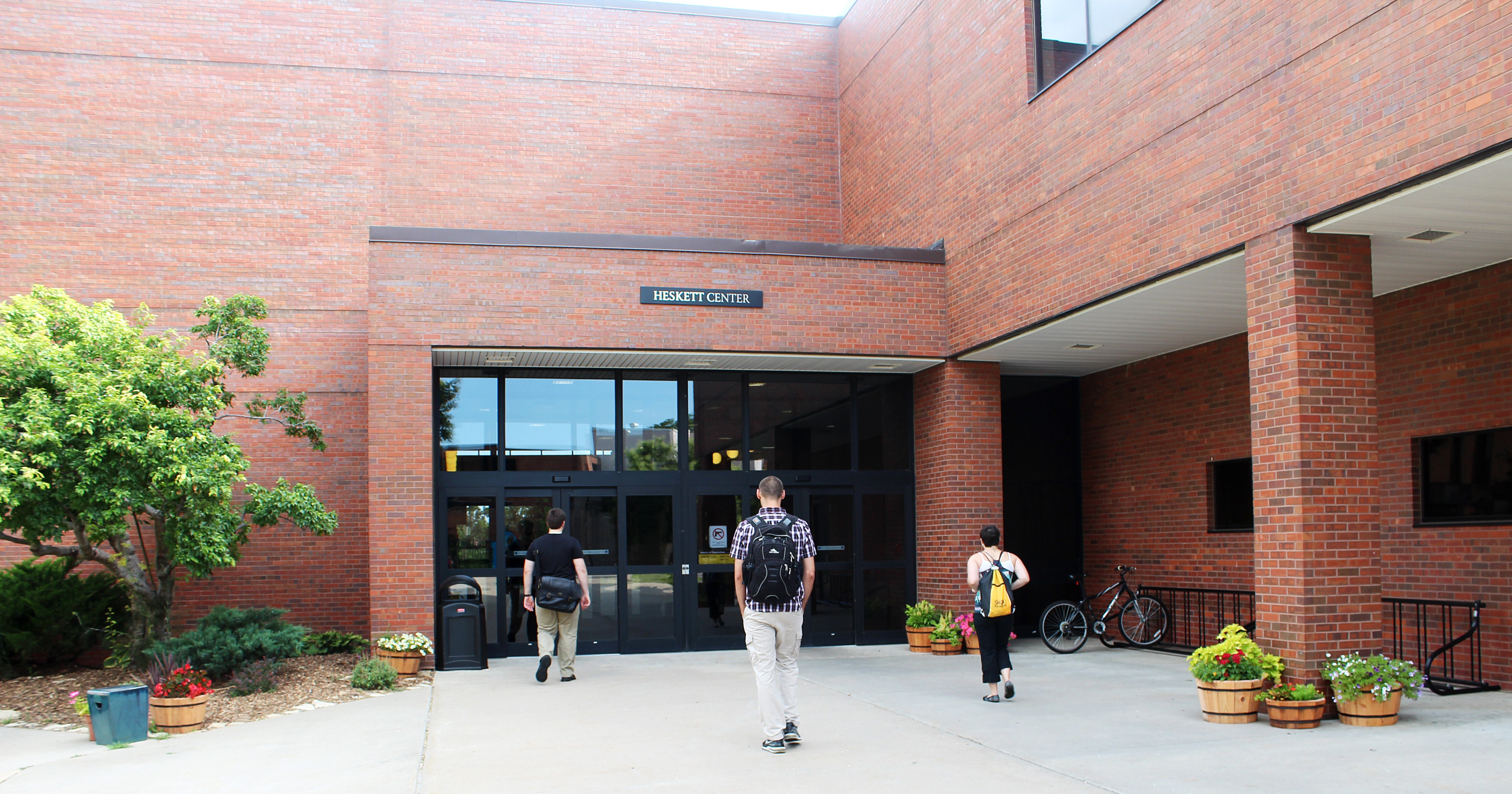 three students heading for the entrance of the Heskett Center