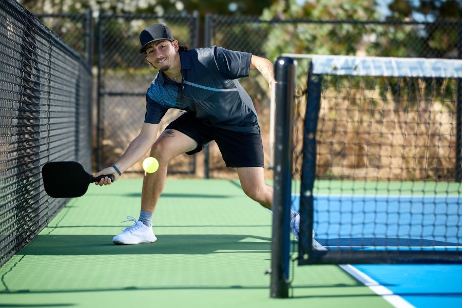 Pickleball player getting ready to hit a ball