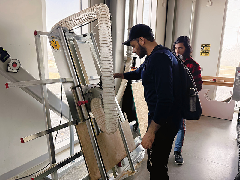 Abbas Minhal Abbas Minhal uses a vertical panel saw during a woodworking workshop at the Prairie Innovation Hub woodshop.