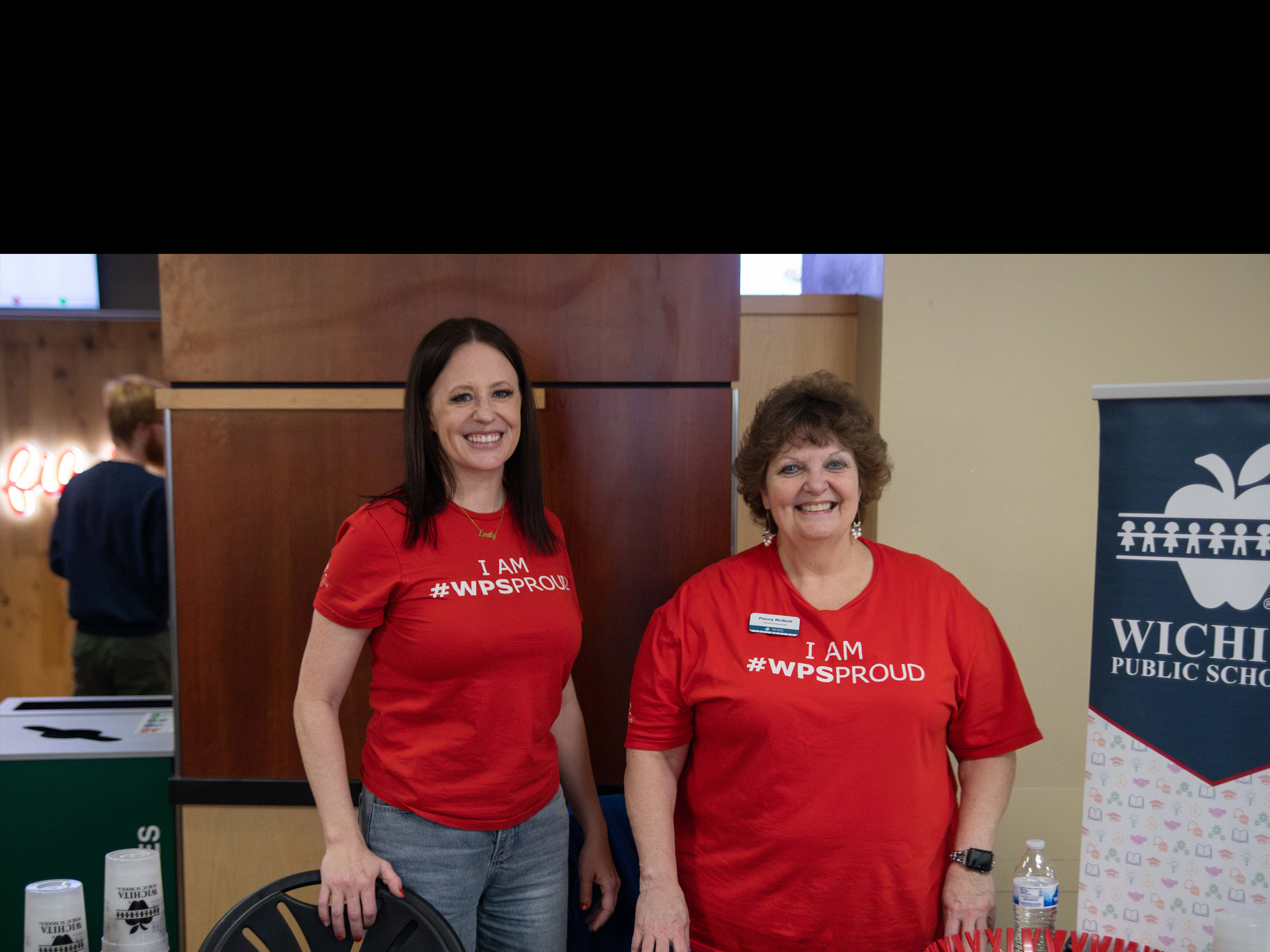 Wichita Public School Table Staff Smiling Towards Camera
