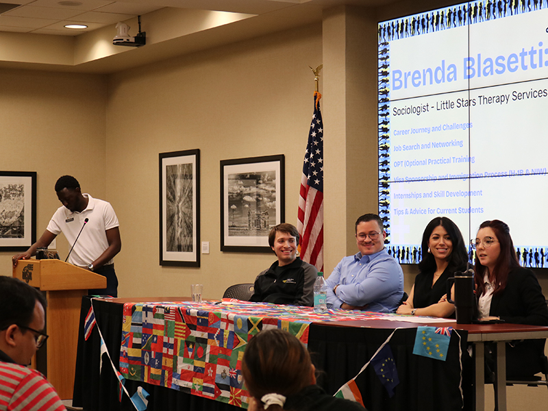 A panel of Wichita State alumni international students meets to share their stories and answer questions.