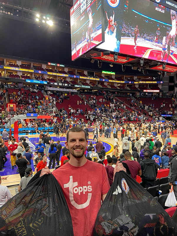 guy stands in crowded gym
