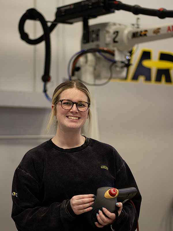 Haylee Thurman works with the robots in the NIAR Automation Research Center.