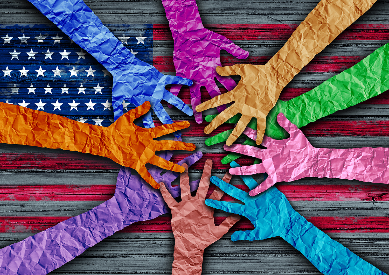 multi-color paper hands meeting over an American flag