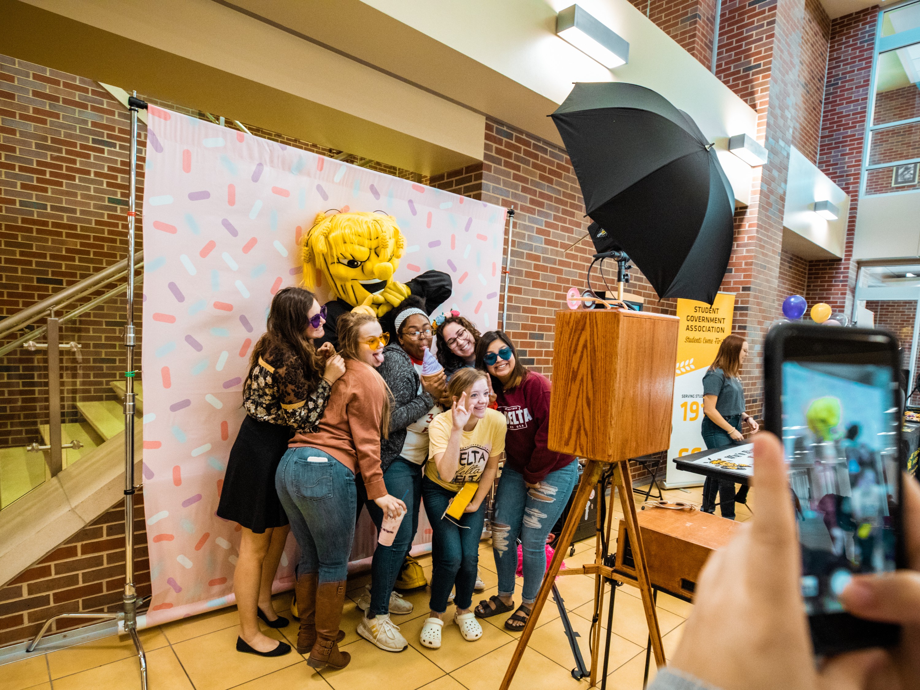 Students standing in a photo boot with Wu Shock