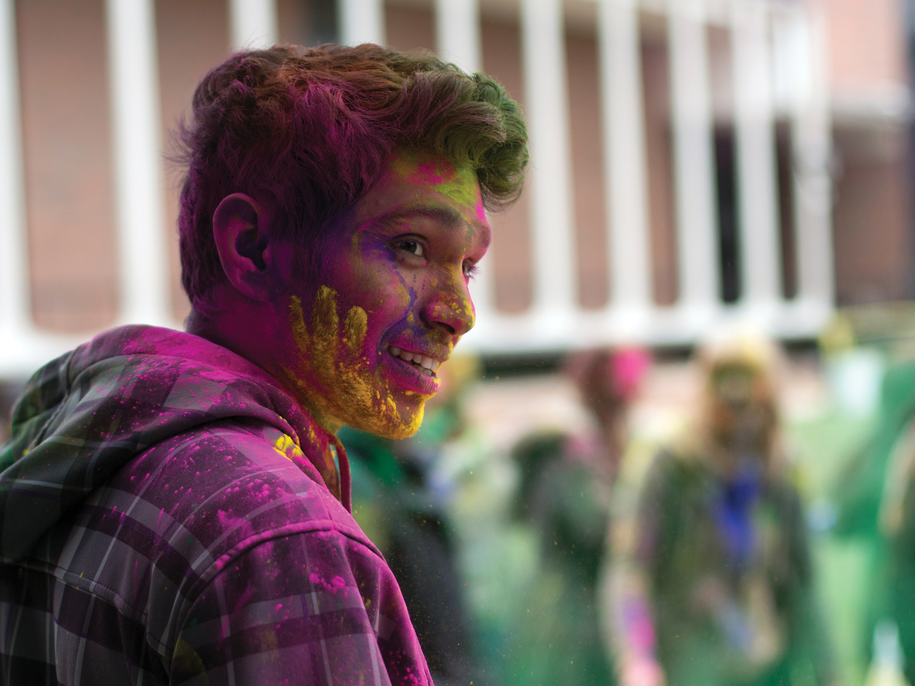 Student participating in Holi celebration