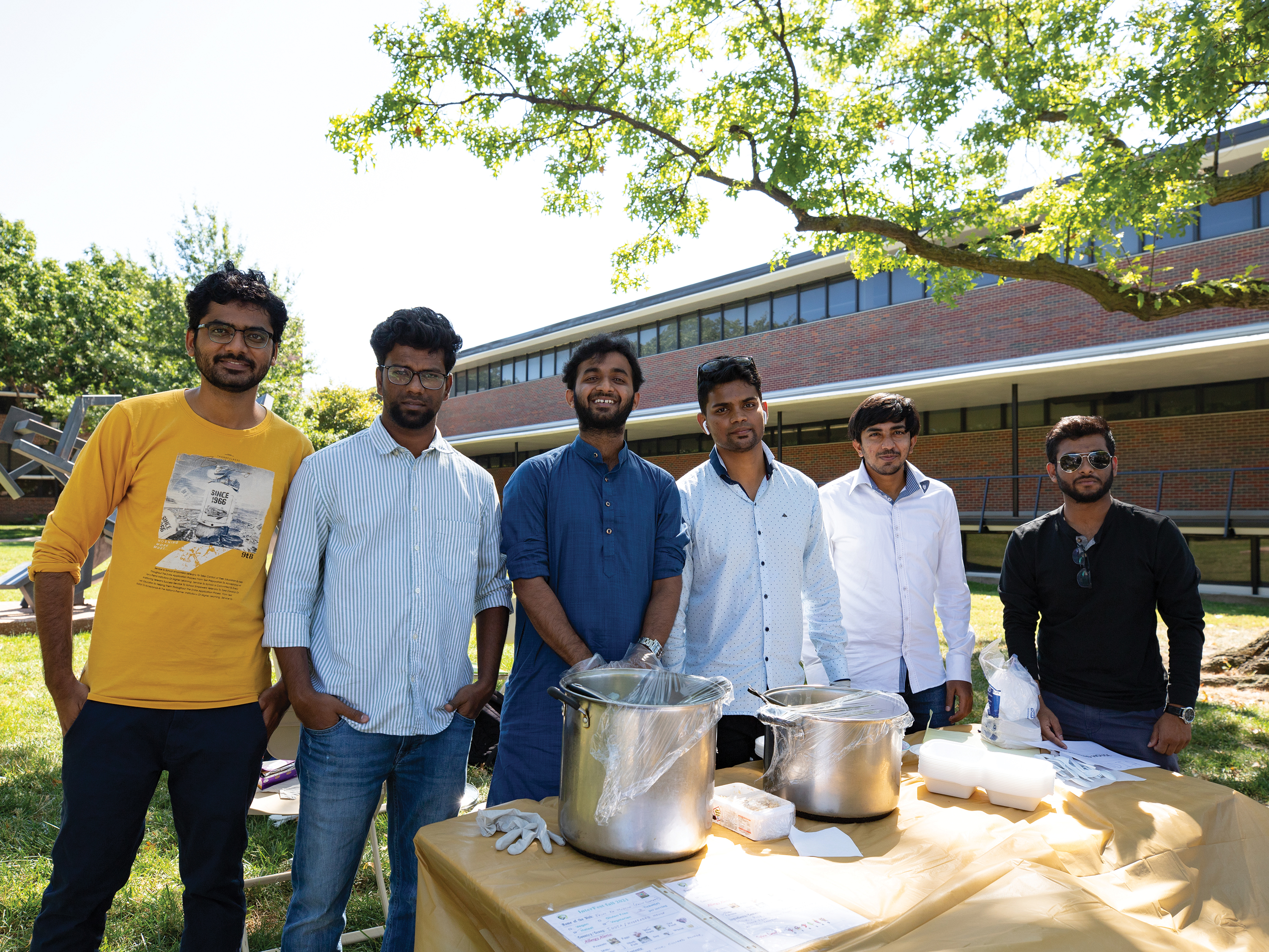 Group of students posing for the camera while selling food at Interfest