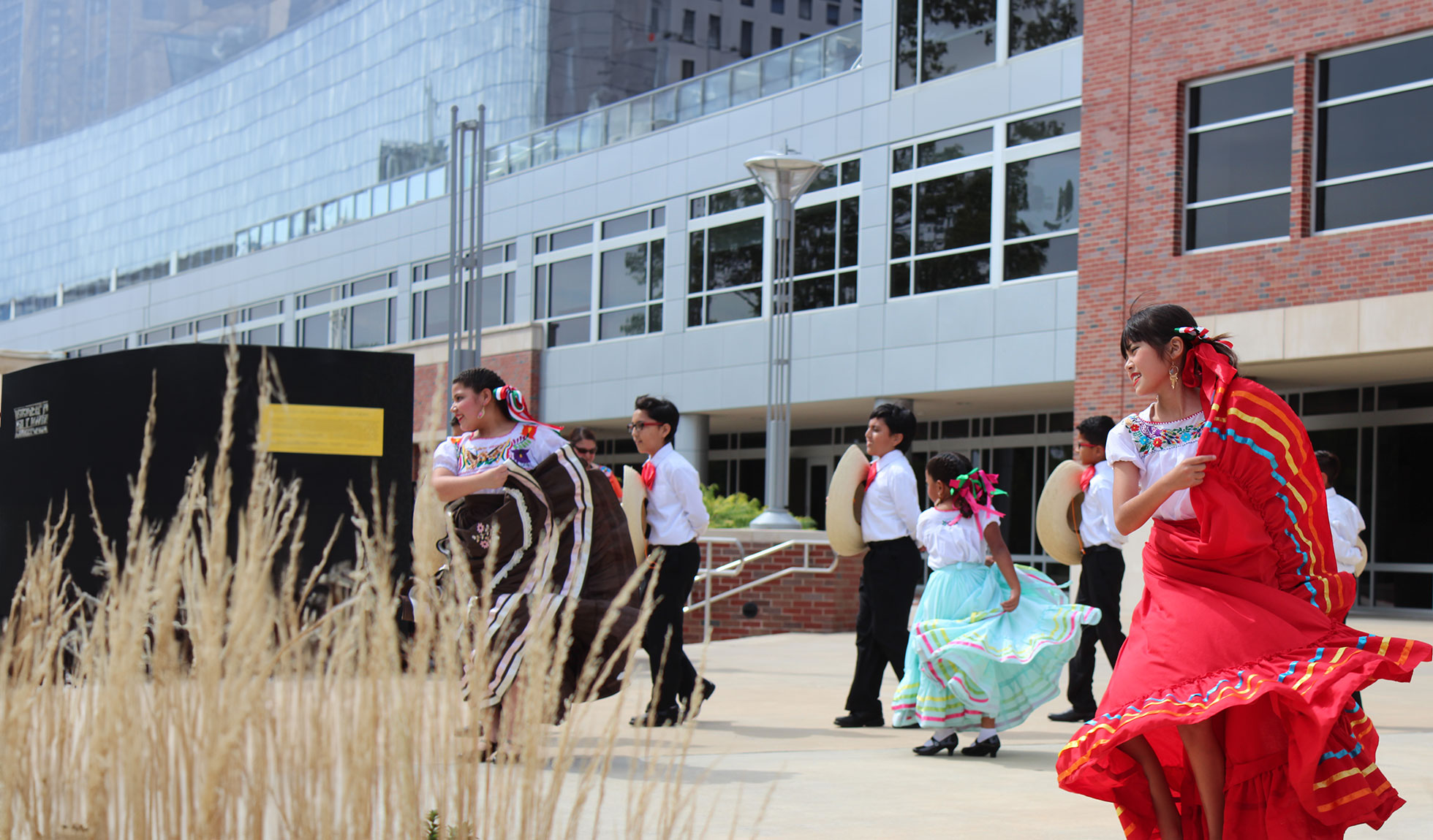 Young children dancing to a traditional song at Latinx Heritage Month Celebration.